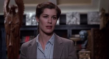 Movie still from “Videodrome” (1983), directed by David Cronenberg – A person wearing a suit and tie; Close Up shot, Over the shoulder angle