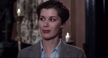 Movie still from “Videodrome” (1983), directed by David Cronenberg – A person wearing a suit; Close Up shot, Over the shoulder angle
