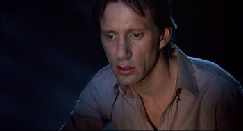 Movie still from “Videodrome” (1983), directed by David Cronenberg – A person wearing a brown shirt; Close Up shot, Low angle