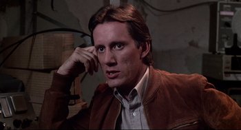 Movie still from “Videodrome” (1983), directed by David Cronenberg – A person wearing a brown jacket; Close Up shot, Low angle