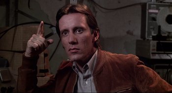 Movie still from “Videodrome” (1983), directed by David Cronenberg – A person wearing a brown jacket; Close Up shot, Low angle