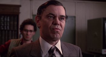 Movie still from “Videodrome” (1983), directed by David Cronenberg – A man in a suit and tie looking angry; Close Up shot, Low angle