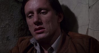 Movie still from “Videodrome” (1983), directed by David Cronenberg – A person wearing a brown jacket; Close Up shot, Low angle