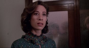 Movie still from “Videodrome” (1983), directed by David Cronenberg – A person wearing a green shirt; Close Up shot, Low angle