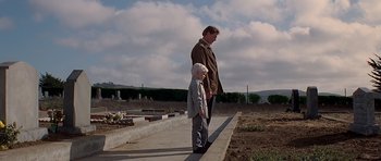 Movie still from “Village of the Damned” (1995), directed by John Carpenter – A man and a boy standing next to each other on a sidewalk; Wide shot, Low angle