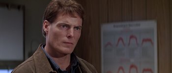 Movie still from “Village of the Damned” (1995), directed by John Carpenter – A person wearing a jacket; Close Up shot, Over the shoulder angle