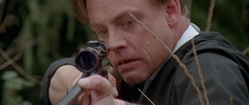 Movie still from “Village of the Damned” (1995), directed by John Carpenter – A person holding a camera; Close Up shot, Low angle