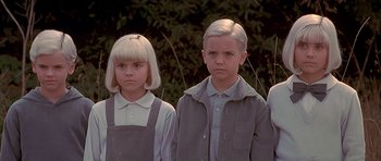 Movie still from “Village of the Damned” (1995), directed by John Carpenter – A group of children standing next to each other; Close Up shot, Low angle
