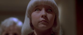 Movie still from “Village of the Damned” (1995), directed by John Carpenter – A person wearing a white wig; Close Up shot, Low angle