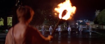 Movie still from “Village of the Damned” (1995), directed by John Carpenter – A group of people standing in the middle of a street; Wide shot, High angle