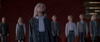 Movie still from “Village of the Damned” (1995), directed by John Carpenter – A group of people standing next to each other; Medium shot, Low angle