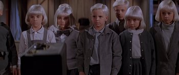 Movie still from “Village of the Damned” (1995), directed by John Carpenter – A group of young people standing next to each other; Medium shot, Low angle
