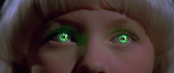 Movie still from “Village of the Damned” (1995), directed by John Carpenter – A person's eyes with green eyes; Extreme Close Up shot, Low angle