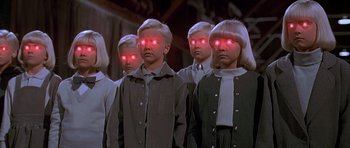 Movie still from “Village of the Damned” (1995), directed by John Carpenter – A group of kids with red eyes on their heads; Medium shot, High angle