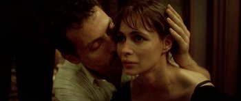 Movie still from “Vinyan” (2008), directed by Fabrice du Welz – A man and a woman are kissing in a room; Close Up shot, High angle