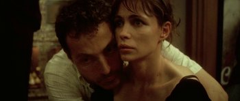 Movie still from “Vinyan” (2008), directed by Fabrice du Welz – A man and a woman pose for a picture; Close Up shot, High angle