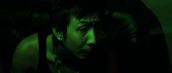 Movie still from “Vinyan” (2008), directed by Fabrice du Welz – A man with a green light on his face; Close Up shot, Low angle