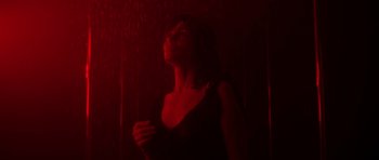 Movie still from “Vinyan” (2008), directed by Fabrice du Welz – A woman standing in the dark with her eyes closed; Medium shot, Low angle