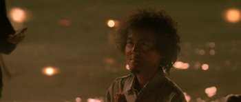 Movie still from “Vinyan” (2008), directed by Fabrice du Welz – A man with a curly hair is looking at the camera; Close Up shot, Low angle