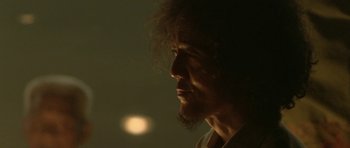 Movie still from “Vinyan” (2008), directed by Fabrice du Welz – A person's face in the dark; Close Up shot, Low angle