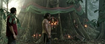 Movie still from “Vinyan” (2008), directed by Fabrice du Welz – A man standing in the middle of a forest; Wide shot, Low angle