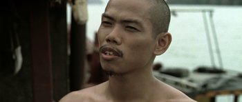 Movie still from “Vinyan” (2008), directed by Fabrice du Welz – A person with a shaved head; Close Up shot, Low angle