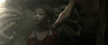 Movie still from “Vinyan” (2008), directed by Fabrice du Welz – A young boy being shaved by an older person; Close Up shot, Over the shoulder angle