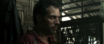 Movie still from “Vinyan” (2008), directed by Fabrice du Welz – A person wearing a red shirt; Close Up shot, Low angle