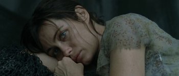 Movie still from “Vinyan” (2008), directed by Fabrice du Welz – A person laying on the ground; Close Up shot, Over the shoulder angle