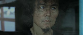 Movie still from “Vinyan” (2008), directed by Fabrice du Welz – A person with a beard; Close Up shot, Low angle