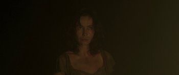 Movie still from “Vinyan” (2008), directed by Fabrice du Welz – A woman is looking at the camera in the dark; Close Up shot, Low angle