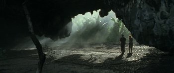 Movie still from “Vinyan” (2008), directed by Fabrice du Welz – A man standing in front of an open cave; Extreme Wide shot, Low angle