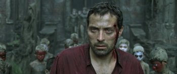 Movie still from “Vinyan” (2008), directed by Fabrice du Welz – A person with blood all over his face; Close Up shot, High angle