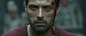 Movie still from “Vinyan” (2008), directed by Fabrice du Welz – A person with blood on his face; Close Up shot, Low angle