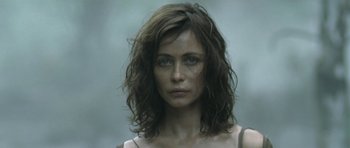 Movie still from “Vinyan” (2008), directed by Fabrice du Welz – A person with long brown hair; Close Up shot, Low angle