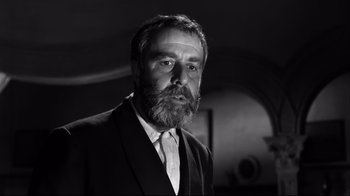 Movie still from “Viridiana” (1961), directed by Luis Buñuel – Black and white photograph of a man in a suit; Close Up shot, Low angle