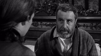 Movie still from “Viridiana” (1961), directed by Luis Buñuel – An older man and a young woman are talking to each other; Close Up shot, Over the shoulder angle