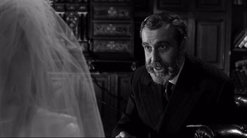 Movie still from “Viridiana” (1961), directed by Luis Buñuel – An older man sitting in front of a bride; Close Up shot, Over the shoulder angle