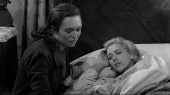 Movie still from “Viridiana” (1961), directed by Luis Buñuel – A woman sitting next to a woman laying in a bed; Close Up shot, High angle