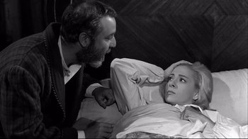 Movie still from “Viridiana” (1961), directed by Luis Buñuel – A man and a woman are in a hospital bed; Medium shot, High angle