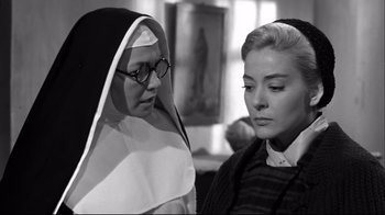 Movie still from “Viridiana” (1961), directed by Luis Buñuel – A nun and a woman are looking at each other; Close Up shot, Low angle