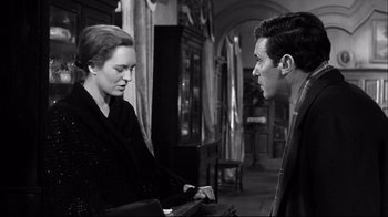 Movie still from “Viridiana” (1961), directed by Luis Buñuel – A man and a woman are talking in a room; Medium shot, Over the shoulder angle