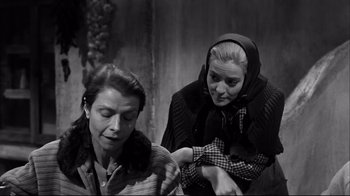 Movie still from “Viridiana” (1961), directed by Luis Buñuel – Two women are sitting next to each other; Medium shot, Over the shoulder angle