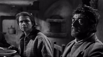 Movie still from “Viridiana” (1961), directed by Luis Buñuel – A man and a woman sitting next to each other; Medium shot, Low angle