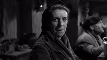 Movie still from “Viridiana” (1961), directed by Luis Buñuel – An older woman wearing a hood and a jacket; Close Up shot, Low angle