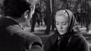 Movie still from “Viridiana” (1961), directed by Luis Buñuel – A young woman wearing a hood and a scarf is talking to a young man; Close Up shot, Low angle