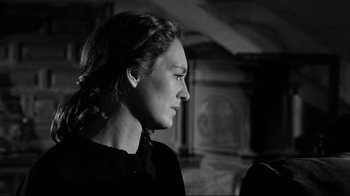 Movie still from “Viridiana” (1961), directed by Luis Buñuel – A black and white photo of a woman looking to the side; Close Up shot, Over the shoulder angle