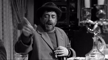 Movie still from “Viridiana” (1961), directed by Luis Buñuel – An old man wearing a hat is holding a cigarette; Close Up shot, Low angle