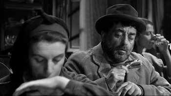 Movie still from “Viridiana” (1961), directed by Luis Buñuel – An older man and woman sitting next to each other; Close Up shot, Low angle