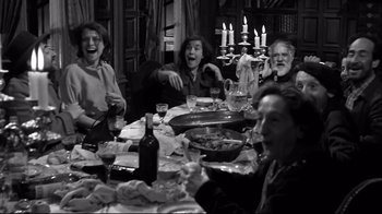 Movie still from “Viridiana” (1961), directed by Luis Buñuel – A group of people sitting at a dinner table; Medium shot, High angle
